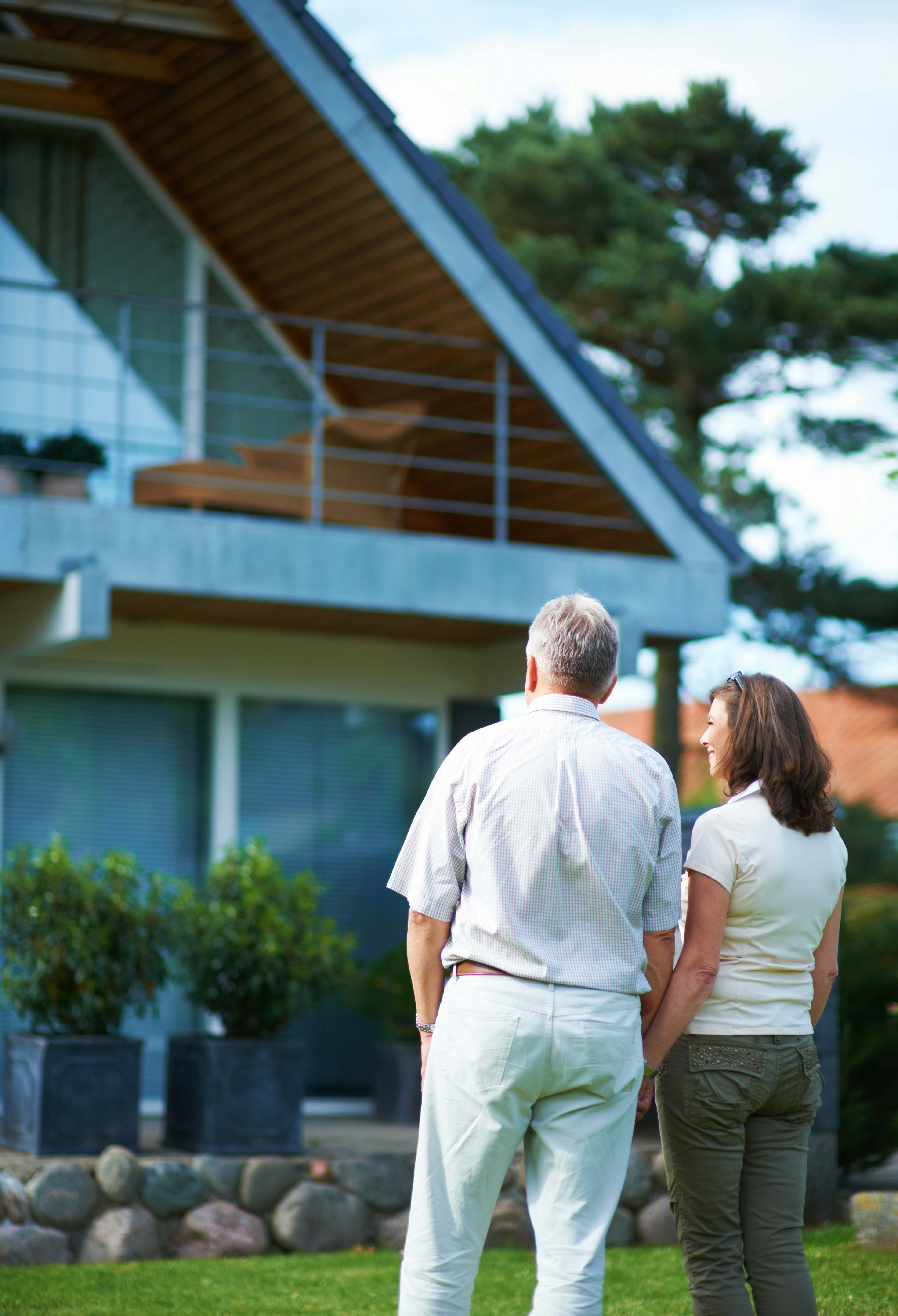 rearview shot of a mature couple standing hand in hand